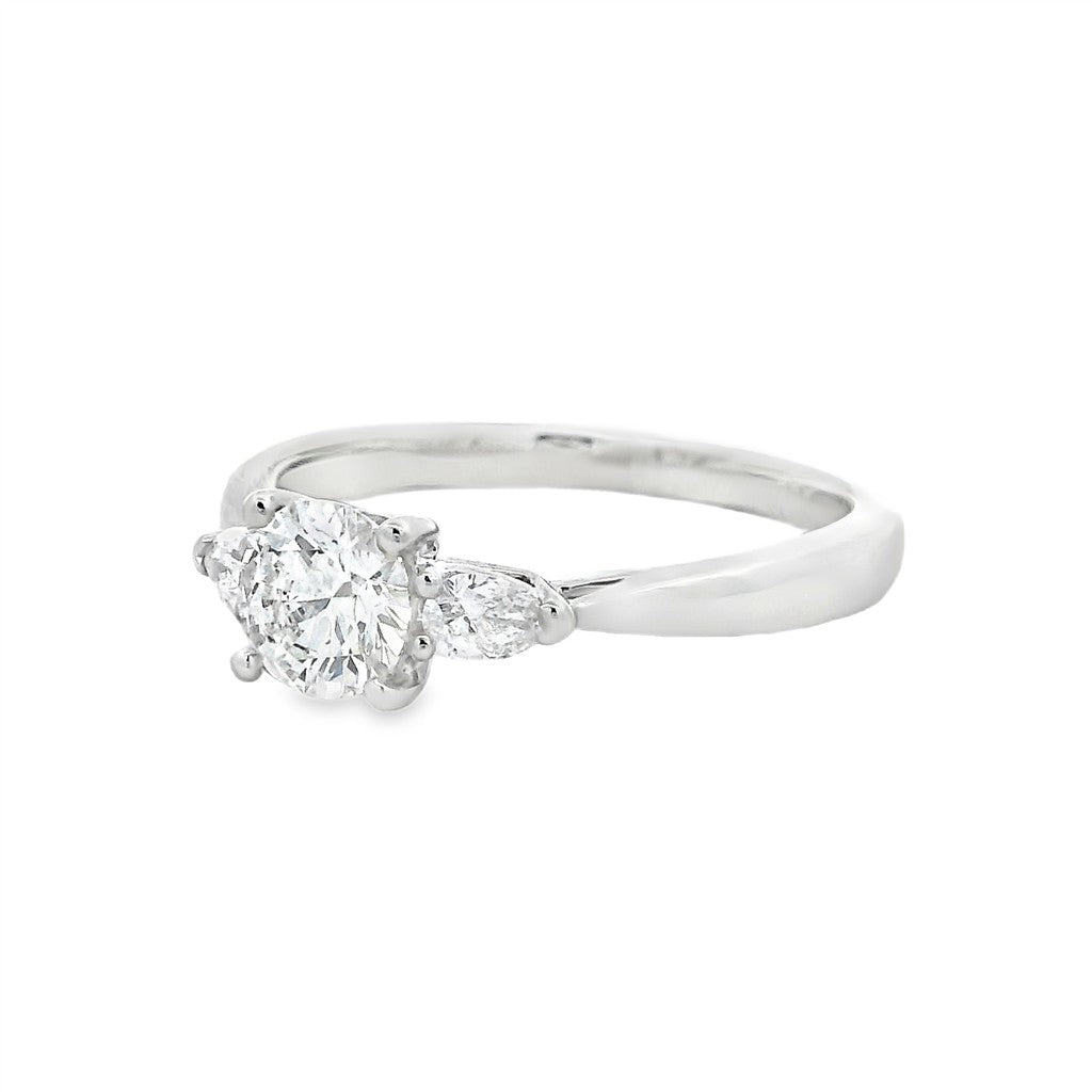 Three Stone Diamond Engagement Ring White Platinum With A 0.57 Carat Round Shape Diamond Center & Pear Shape Diamonds Side Stones