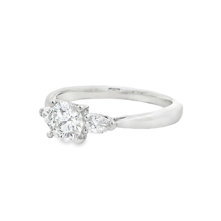 Three Stone Diamond Engagement Ring White Platinum With A 0.57 Carat Round Shape Diamond Center & Pear Shape Diamonds Side Stones